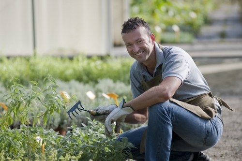 Landscaper wearing PPE while working on a Newham garden project
